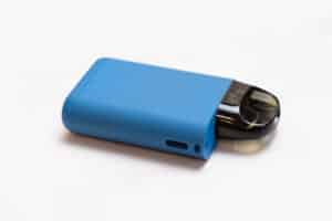 POD-system for smoking on a light background. A device with a replaceable cartridge for nicotine liquid. An electronic cigarette for smoking.