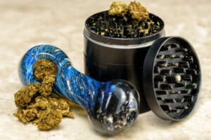 Close up of medical marijuana bud with a glass pipe
